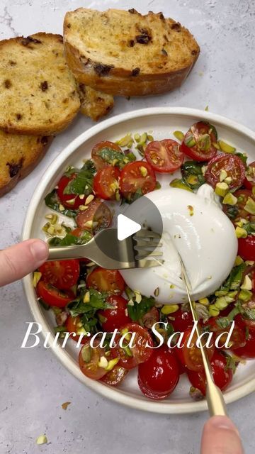 BORED OF LUNCH on Instagram: "Burrata Salad with Airfried Bread 🍅🥖 

I had this nearly every day in Italy and it lives in my head rent free. Burrata is so underrated you can get it in most supermarkets. If you’re hosting friends this summer you NEED to make this. 

1. In a bowl mix up 
- Tomatoes 🍅 
- Basil 🌿 
- 1 tbsp olive oil 🫒 
- 1 tbsp balsamic 
- 2 grated garlic cloves 🧄
- Salt & Pepper 

2. Add oil to some bread and airfry at 200 for 7 mins. It is so so crispy and just ridiculous. 

3. Add the mixed tomatoes to the Burrata, top with some crushed pistachios and dig in. 

Insane. Plate here is from the incomparable @zaramclaughlin.studio 

#bread #airfryer #burrata #burratacheese #italy #italian #food #hungry #asmr #lunch #dinner #salad #salads #tomatoes #foodies" Bread Airfryer, Burrata Salad, Hosting Friends, Burrata Cheese, Dinner Salad, Tomato Basil, In My Head, Italian Food, Pistachio