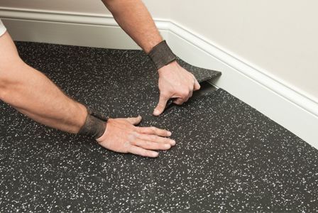 Man installing rubber flooring in garage Rubber Flooring Basement, Rubber Flooring Bathroom, Rubber Flooring Kitchen, Rubber Garage Flooring, Outdoor Rubber Flooring, Garage Flooring Options, Rolled Rubber Flooring, Basement Flooring Options, Garage Boden