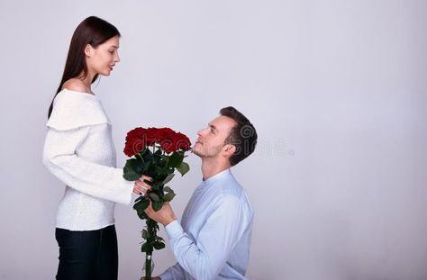 Man giving flowers to woman on knees Man Gives Flowers To Woman, Man On His Knees For Woman Aesthetic, Man Begging On His Knees, Man Giving Flowers To Woman, Woman On Knees, Man Giving Flowers, Man Kneeling, Evermore Era, Giving Flowers