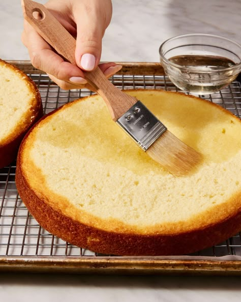 Baker brushing simple syrup cake soak onto round cake layer Simple Syrup For Cakes, Cake Soak, King Arthur Recipes, Yellow Butter Cake, Baking A Cake, Syrup Cake, Two Layer Cakes, Cake From Scratch, Baking School