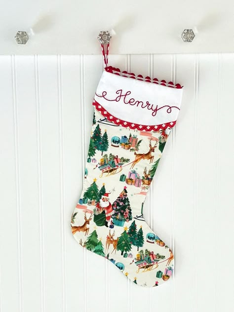 Our beautifully quilted Christmas stockings measure 20" diagonally from bottom of loop to tippy toe. Order with or without a matching red gingham bow. Our signature ric rac trim, custom hand embroidered name, red gingham trim and quilting make this a timeless addition to your Christmas decor. Fully lined with batting and piecing on both sides. You'll love the added surprise of how our cuff overlaps in the back. :: LEAD-TIME :: Please see shipping tab for current lead-time on Christmas stockings. Christmas Stockings To Sew, Matching Family Stockings Christmas, Hand Sewn Stocking, Vintage Stockings Christmas, Needle Point Stocking, Embroidered Stockings Christmas, Quilted Christmas Stockings Ideas, Needlepoint Stockings Christmas, Quilted Stockings Christmas