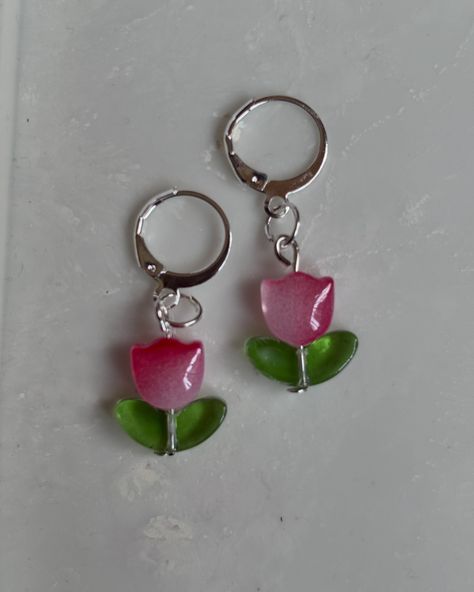 Pink Tulip Earrings These charming Pink Tulip Earrings are handmade with care and attention to detail. The delicate tulip design will add a touch of elegance to any outfit, making them perfect for both everyday wear and special occasions. Pair these pretty earrings with a simple blouse or dress to let them stand out, or mix and match with other floral accessories for a fun and stylish look. To keep your Pink Tulip Earrings looking their best, store them in a dry place away from sunlight a... Tulip Earrings, Tulip Design, Simple Blouse, Floral Accessories, Pink Tulips, Outfit Making, Pretty Earrings, Special Occasion, Everyday Wear