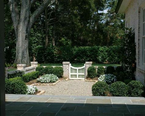 A pea gravel courtyard surrounded with brick, boxwood and flowers. Also, driveway gate inspo! Pea Gravel Garden, Pea Gravel Patio, Shed Landscaping, Gravel Landscaping, Gravel Patio, Gravel Garden, Pea Gravel, Luxury Garden, Backyard Makeover