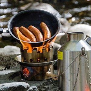 Cooking sausages on a 'hobo' stove Hobo Stove, Outdoor Cooking Stove, Kelly Kettle, Best Camping Stove, Camping Plates, Camping Kettle, Camp Stove, Stainless Steel Kettle, Camping Kit