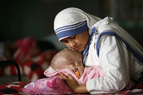 BANGLADESH/Sister Angelita, of Missionaries of Charity, holds 4-month old Michael who has hydrocephalus, a condition with excessive accumulation of fluid in the brain, at an orphanage in Old Dhaka, Bangladesh, November 18, 2009. REUTERS/Andrew Biraj Old Dhaka, Missionaries Of Charity, 4 Month Old Baby, Bride Of Christ, Dhaka Bangladesh, 4 Month Olds, Roman Catholic Church, Women Of Faith, Latest News Today