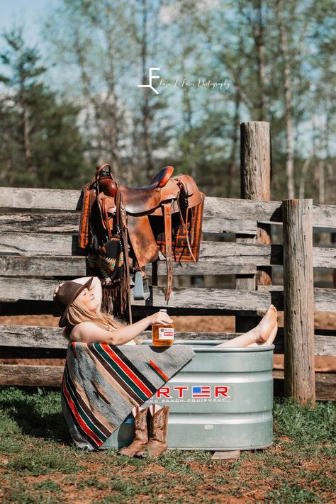 Laze L Farm Photography | Beth Dutton Water Trough | posing in the trough with the whisky bottle Water Trough Photoshoot, Farm Work, Beth Dutton Water Trough Photoshoot, Western Budiour Photography Ideas, Horse Water Trough, Western Bodouir Photoshoot, Bouduar Photos Country, Photo Shoot With Horses Cowgirl, Boudiour Poses