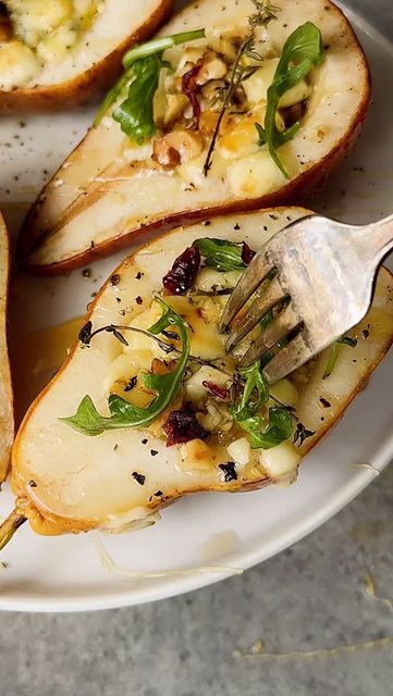 Caitlin Latessa-Greene on Instagram: "ROASTED PEARS WITH GORGONZOLA & HOT HONEY! Super fun holiday app or side idea—so freaking delish— EASY tasty app/side for the holiday!
•
•
For the filling:
1 cup chopped gorgonzola cheese
1/2 cup chopped walnuts
1 tbsp fresh thyme
•
For the pears:
4 ripe pears, sliced in half then scooped out
Salt
Pepper
2-3 tbsp hot/spicy honey
•
For the toppings:
Chopped dried cranberries (optional)
Baby arugula
Black pepper
Extra hot honey (optional)
•
•
1️⃣Preheat the oven to 425. 2️⃣Add the cheese, walnuts and thyme one at a time to a cutting board. Chop each item a few times, then continue to add and chop until well combined.3️⃣Add the pears to the baking sheet, season with salt and pepper, then add a couple spoonfuls to each pear half. Add a generous drizzle of Roasted Pears, Ripe Pears, Roasted Pear, Gorgonzola Cheese, Baby Arugula, Spicy Honey, Hot Honey, Fancy Food, Hot Spicy