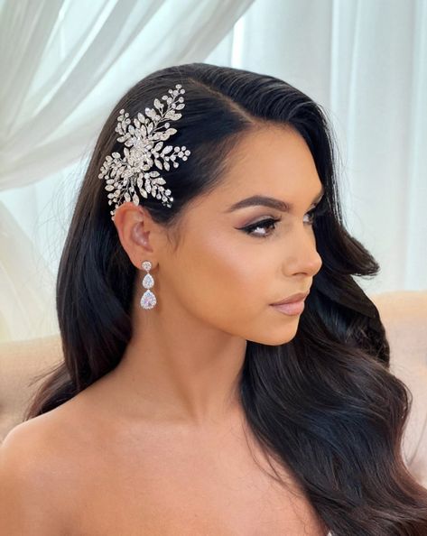 This delicate bridal hair comb is the perfect way to add a romantic and elegant glow to your wedding look. Its intricate detailing and finely placed crystals softly sparkle throughout this elegant piece. With its flexible build, it can be placed in a wide variety of styles. Available in all crystal or crystal with pearl detailing. -Genuine crystals -Approximately 3.5in wide x 5.4in long (8.9cm x 13.7cm) -Comb added for extra comfort and stability -Rhodium plated, non-tarnish finish for brillianc Wedding Hairstyles With Comb On Side, Hollywood Waves With Side Clip, Bridal Hair Down With Clip, Glitter Wedding Hair, Bridal Hairpiece Hair Down, Bridal Hair With Clip, Classy Bridal Hair, Wedding Hair Comb Side, Camp Hairstyles