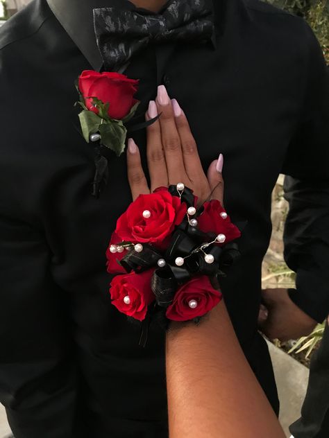 Red roses, all black ribbons with white pearls Red Black Corsage, Red And Black Prom Corsage, Black And Red Prom Flowers, Black And Red Boutonniere, Red Flower Corsage, Red And Black Corsage And Boutonniere, Red Hoco Flowers, Red Rose Corsage And Boutonniere, Prom Corsage And Boutonniere Red