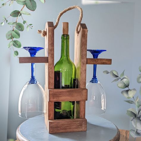 "This personalized wooden wine carrier is the perfect way to carry or display your wine. This wine bottle and glass holder also makes a perfect gift for a wine lover. Add a personalization for a rememberable present for Weddings, Bridal Showers, Housewarming or Hostess gift. The wooden wine caddy measures 14\" x 12\" x 3.5\". It is made out of select pine wood and the color of the stain is Special Walnut. The rope handle adds a rustic touch. The wine caddy can hold one bottle of 750ml wine and t Wine Bottle And Glass Holder, Wine Themed Wedding, Wood Wine Bottle Holder, Wine Tray, Wood Inspiration, Wine Gift Tags, Wine Bottle Charms, Business Vision, Rustic Wine Racks