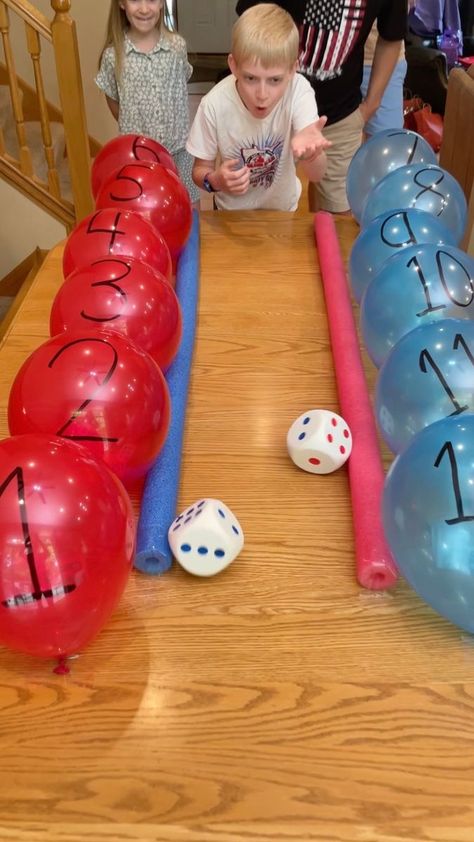 Roll a Number, Pop the Balloon 🎈 | prize | Roll a Number, Pop the Balloon 🎈 Dad, kids, and family play dice rolling table game where they pop balloons for prizes. Punishment at the end (for... | By Benson Bros Family Christmas Dice Roll Game, Dice Roll Game, Prize Game Ideas, Kids Prizes For Games, Christmas Balloon Game, Sucker Pull Game, Pop The Balloon Game, Balloon Popping Game, Win Money Games