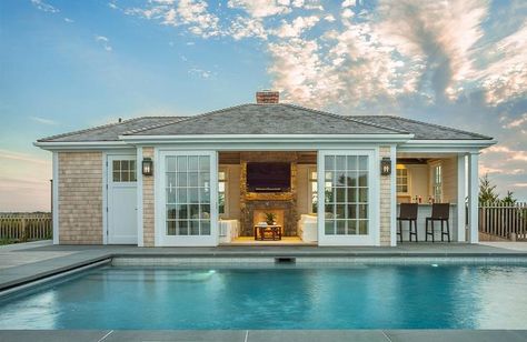 Cottage style pool house is decked with light brown shingles and white trim along with sliding glass doors. Backyard Pool House, Pool Guest House, Pool Diy, Living Pool, Pool House Designs, Pool House Plans, Pool Cabana, New England Homes, Casa Exterior