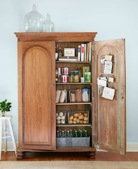 There's no need for built-ins when you turn an armoire into a pantry. Add or remove shelves to suit your needs—locker baskets and metal troughs make it easy to sort dry goods and bottled beverages. Click through for more smart ideas for kitchen pantry organization. Stand Alone Kitchen Pantry, Armoire Pantry, Latest Kitchen Trends, Beautiful Pantry, Vintage Armoire, Kitchen Storage Space, Pantry Shelving, Bedroom Armoire, Kitchen Organization Pantry