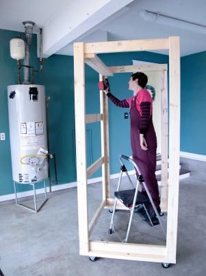 Hide Your Water Heater With a DIY Storage Cabinet | HGTV Hidden Water Heater Garage, Basement Hide Furnace, Hiding Water Heater In Garage, Hide Garage Water Heater, Water Heater Cabinet Diy, Hidden Furnace And Water Heater, Hide Hvac Unit Indoors, Furnace Cover Ideas Basements, Hide Hot Water Heater In Garage