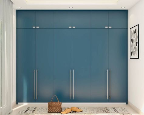 Modern Matt Blue Finished Wardrobe Design with Metallic Handles | Livspace Matt Finish Wardrobe, Blue Wardrobe Bedroom, Strip Lighting Ceiling, Cupboard Design Bedroom, 3 Door Wardrobe Design, Bedroom Royal, Bedroom Navy, Modern Wardrobe Design, Royal Decor