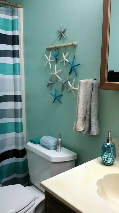 Bathroom accessories added. Made the hanging starfish with twine, wooden dowel, paint, and of course hot glue. Bathroom Ideas Nautical, Sea Decor Bathroom, Beach Theme Bathroom Diy, Diy Beach Bathroom Decor, Anchor Bathroom Decor, Anchor Bathroom, Mom Bathroom, Ocean Bathroom, Nautical Bathroom Decor