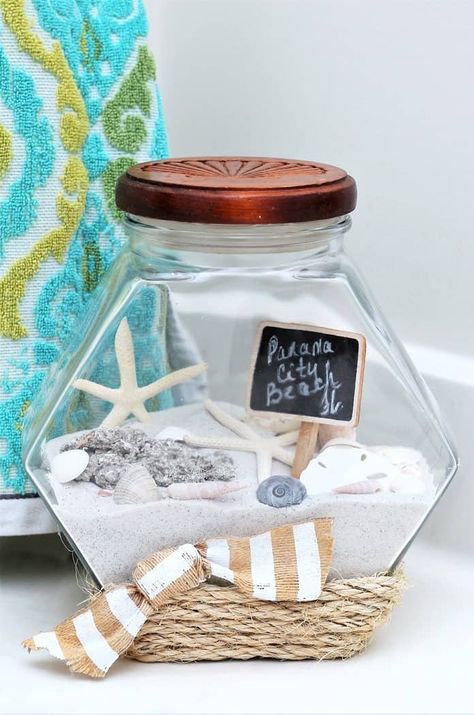 vacation memory jar includes beach sand and seashells along with sisal rope glued to jar Beach Sand Crafts, Beach Memory Jars, Beach Jar, Diy Dollar Tree Centerpieces, Dollar Tree Centerpieces, Personalized Centerpieces, Memory Jars, Shell Display, Jar Display