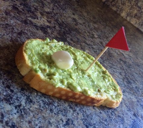 "Hole in one" crostini. Toasted bread Avocado spread Mozzarella ball Flag on a toothpick Masters party Golf party Golf Theme Party Appetizers, Masters Party Snacks, Masters Themed Appetizers, The Masters Party Food, 19th Hole Golf Party, Masters Party, Avocado Spread, Toasted Bread, Golf Party