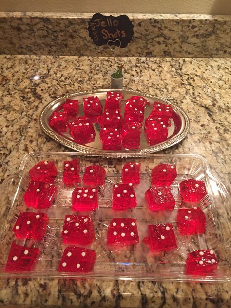 Jell-O shots made into dice.  Not as easy as I thought.  Used sprinkles- white confetti for the dots.  You can also use food writer pen but those bleed a little bit so you can’t do advanced prep too far ahead. Dice Jello Shots, Vegas Party Theme Food, Casino Jello Shots, Casino Theme Party Food Snacks, Casino Theme Jello Shots, Vegas Party Food, Casino Theme Party Decorations Diy Ideas, Casino Theme Party Food Appetizers, Casino Night Party Ideas