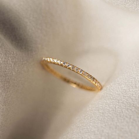 Our classic eternity ring dusted with 1.2mm white topaz stones on a gold band. This ring is also available in 14k gold and diamond. Second Band Wedding Ring, Wedding Ring With Eternity Band, Gold Wedding Band Ring, Diamond Pearl Wedding Band, Eternity Band Wedding Ring, Gold Wedding Band With Diamonds Women, Simple Gold Rings Engagement, Eternity Ring Wedding Band, Gold Diamond Band Ring