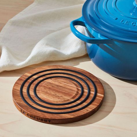 Protect surfaces from heat in handsfree effortless style with the Magnetic Wooden Trivet. Crafted from beautiful acacia wood, the 8-inch circular trivet features a mag Magnetic Trivet, Pumpkin Apple Soup, Product Wishlist, French Onion Soup Bowls, Enameled Cast Iron Cookware, Mini Muffin Pan, Utensil Crock, Pumpkin Apple, Silicone Rings