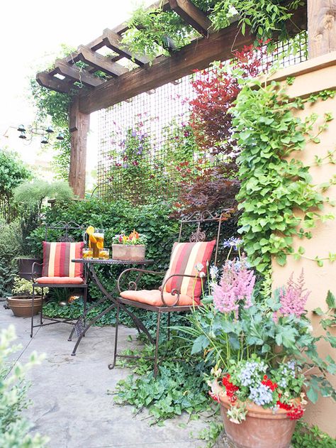 ✤ Landscaping Ideas for Privacy #7 - Create a Restful Nook  Use plants to cocoon a garden spot.  Trees often are used as a canopy over a quiet nook. Here a pergola serves the same purpose.  In place of the heavy-duty look of wood, a delicate metal screen shields two chairs and a table. Arbor Ideas, Patio Gardens, Trellis Ideas, Garden Nook, Patio Privacy, Privacy Landscaping, Side Yards, Garden Privacy, Privacy Screen Outdoor