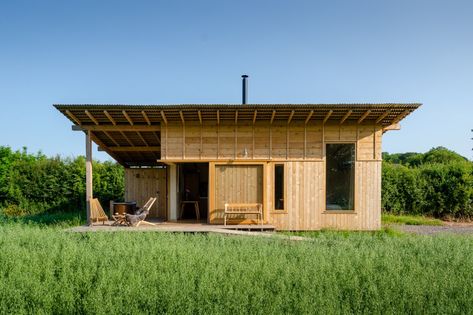 Holly Water Cabin by Out of the Valley - Dwell Wood Interior Walls, English Farm, Monopitch Roof, Modular Cabins, Calm Color Palette, Food Factory, House On Stilts, Off Grid Cabin, Fire Pit Seating