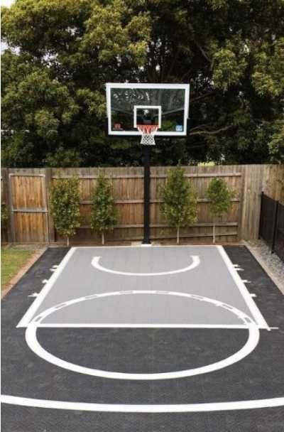 27 Outdoor Home Basketball Court Ideas | Sebring Design Build Backyard Tennis Basketball Court, Basketball Pad In Backyard, Corner Basketball Court, Small Backyard Basketball Courts, Basketball Driveway Ideas, Basketball Area In Backyard, Mini Basketball Court Backyard, Basketball Home Court, Small Home Basketball Court