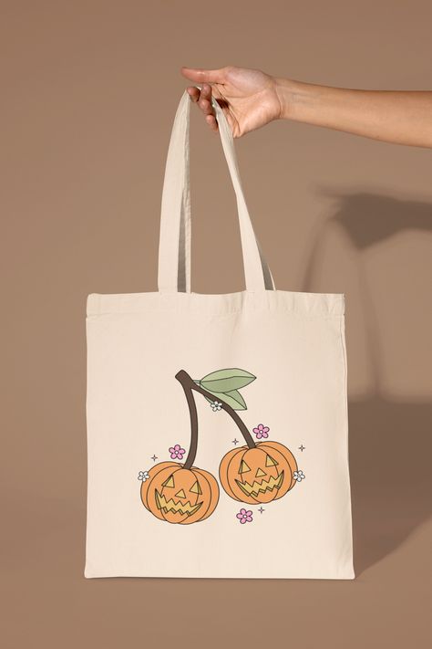 The cutest graphic tote bag to add to your collection. Perfect for everyday large essentials, grocery shopping, post office runs, etc! Details: Medium Tote Bag - 100% Cotton Canvas Dimensions: 15" x 16" All are made to order by me. Halloween Tote Bags Diy Paint, Halloween Tote Bags Diy, Cherry Tote Bag, Custom Totes, Fall Tote Bag, Bag Painting, Fall Tote, Spooky Night, Diy Tote