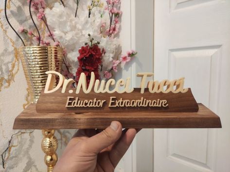 Our product is specially designed and handmade. The wooden table name holder is carefully made from various trees. Personalized table name plate will be the most beautiful decoration of your table with its different and special design. Our products are made of natural wood. In this product, the name parts are made of poplar wood and the pedestal on which the names sit is made of walnut wood. The ground is made of pine or similar trees. approx size: length: 28cm height: 6.75 cm Name Board Design, Table Name Holders, Natural Wood Desk, Custom Desk Name Plates, Doctor Lawyer, Doctor Office Design, Lawyer Office Decor, Name Holder, Personalized Desk Name Plate