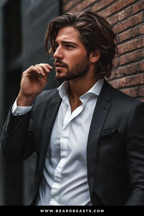 Handsome man with long, layered hair and a neatly trimmed beard, dressed in a sharp suit, leaning against a brick wall. This look perfectly captures a stylish and modern example of men's hairstyles for long hair, combining elegance with a relaxed, confident vibe. Elegant Men Hairstyle, Men Hairstyle Long, Trimmed Beard, Long Haircuts For Men, Best Long Haircuts, Man Buns, Moustache Wax, Guy Haircuts Long, Men Hairstyle