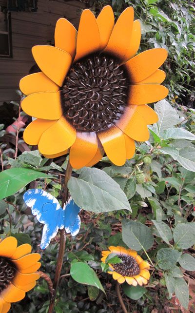 We’re all familiar with the old English adage, “April showers bring May flowers.” For many gardeners, those blooms come in the form of garden art flowers. Whether bold metal sunflowers, ... Welding Metal Flowers, Make Sunflowers, Diy Metal Sunflower Garden Art, Welded Sunflower Keychains, Welded Sunflower Metal Flowers, Welded Rose Metal Flowers, Garden With Flowers, How To Make Sunflower, April Showers Bring May Flowers