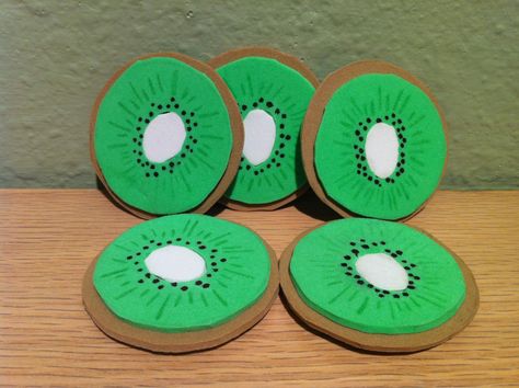 Pretend play kiwi slices made out of foam sheets and detailed with a black sharpie and a green highlighter. All were made slightly irregular like real kiwi slices. Kiwi Crafts For Preschoolers, Kiwi Costume, Bear Crafts Preschool, Vegetable Crafts, Fruit Crafts, Foam Sheet Crafts, Teacher Classroom Decorations, Pretend Food, Gifts Wrapping Diy