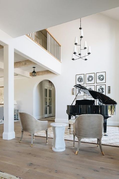 Kate Marker Interiors - Stoffer Photography - Gray leather accent chairs flank a white marble accent table and face a formal living room boasting a piano illuminated by an Aerin Fontaine Vertical Chandelier. Piano Room Design, Grand Piano Living Room, Vertical Chandelier, Modern English Country, Kate Marker Interiors, Piano Room, Beautiful Home Designs, Transitional Living Rooms, Grand Piano