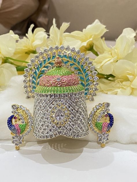 Divine Adornments: Handcrafted Hindu Deity Crowns with 22k Gold Plating and Diamond CZ Accents"

Elevate your spiritual devotion and celebrations with our meticulously handcrafted crowns, designed to honor revered deities such as Lord Venkateswara, Lord Tirupati Balaji, Lord Vishnu, Krishna Laddu Gopal, Sita Ram, and Radha Krishna. Each crown is a masterpiece of divine craftsmanship, exuding the sanctity and reverence these deities embody. Radha Krishna Resin Art, Lord Tirupati Balaji, Vishnu Krishna, Radha Krishna Jewellery Necklaces, Radha Krishna Locket Gold, Radha Krishna Earrings Gold, Gopal Krishna, Janmashtami Celebration, Krishna And Radha