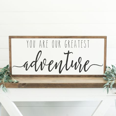 "You Are Our Greatest Adventure ++ ABOUT THIS SIGN ++ SIZE: 13.5\" tall and 31.5\" wide with the frame (Custom sizes available) COLORS SHOWN: White background with black lettering FRAMING: Our signature Espresso stain is used on all of our signs (Custom frame colors available) Our frames have a depth of 1.5\" inches MATERIALS: We use only high quality birch wood for our signs, and finish them with our pine frames.  Each sign is hand-painted and are recommended for indoor use only. QUESTIONS? Ple Our Greatest Adventure Sign, Our Greatest Adventure, Adventure Signs, Family Wood Signs, Adventure Nursery, Diy Dining Room, Hand Painted Wood Sign, Diy Wood Signs, Painted Wood Signs