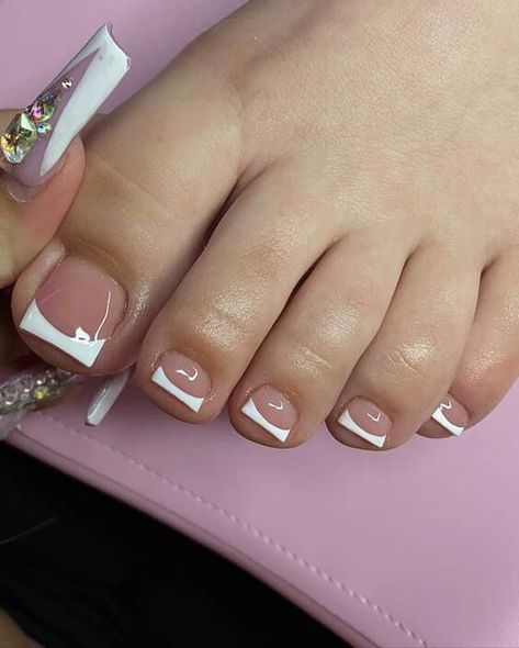 This style elevates minimalism by infusing a contemporary flair into the timeless French toe nail design. With its transparent pink foundation and sharp white highlights crafted in distinctive angular patterns, this manicure epitomizes creativity within simplicity. Ideal for those desiring a refined yet subtly elegant appearance. French Tip With Pink Base, Pink And White French Tip Toes, White French Tip Toes, French Tip Toes With Design, French Toe Nail Designs, French Tips Toes, French Tip Toe Nails, Pink Foundation, Nails Subtle