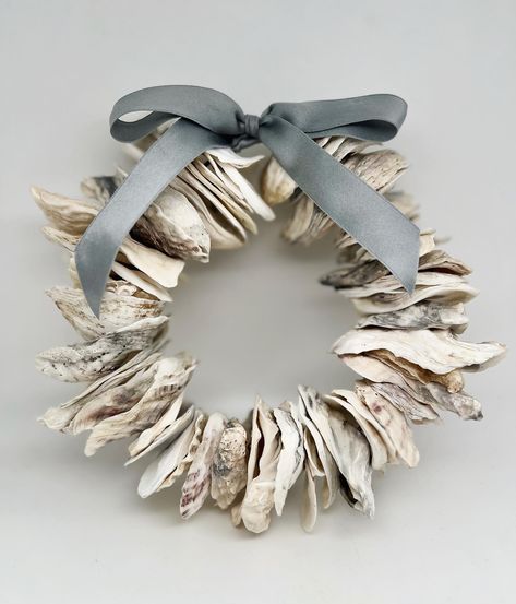 *Update: SOLD* Adding this back in the shop today!!! Get it quick, it will not last. This natural oyster wreath is 7” in diameter and is finished with a sea-grey silk charmeuse ribbon. https://littlesercies.etsy.com #oysterwreath #oystershells #beachywreath #coastaldecor #beachydecor #littlesercies #silkcharmeuse #riverhouse #beachhousedecor #coastalwreath #oystershellart #oystershelldecor #summerwreath #christmasoysterwreath #NCOysters #VAOysters Oyster Wreath, Oyster Shell Wreath, Oyster Decor, Oyster Shells Diy, Oyster Shells Decor, Coastal Wreath, Oyster Shell Crafts, Seashell Wreath, Shell Wreath