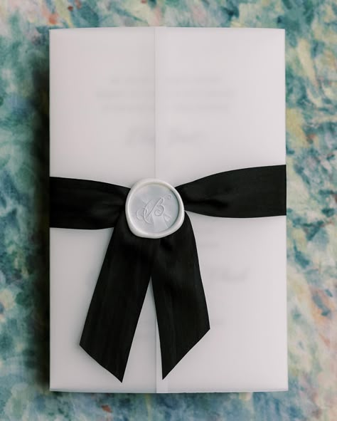 What’s a vellum gatefold? Oh let me tell you! Vellum is this beautiful frosted/translucent paper that we fold around the invitation. Seen her with our black silk ribbon and 1.25” pearl wax seal. Such an awesome addition to any of our wedding invitation suites! Photography: @sarahblazephotog #velluminvitation #velluminvitations #velluminvites #vellum #vellumgatefold #weddingvellum #weddinginvitations #moderninvitations #blackandwhitewedding #weddinginspo Vellum Paper Invitations, Vellum And Ribbon Invitations, Black Wax Seal Wedding Invitations, Vellum Wedding Invitations, Black Wax Seal, Wedding Invitation With Ribbon And Wax Seal, Ribbon Wax Seal Invitation, Wedding Invite Ribbon Wax Seal, Black Ribbon Wedding Invitations