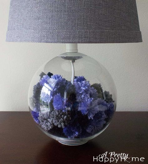 lamp base filled with yarn pom poms Lamp Filler Ideas, Fillable Lamp, Clear Lamp, Yarn Pom Poms, Diy Table Lamp, Diy Outdoor Weddings, Glass Lamp Base, Lamp Ideas, Yarn Pom Pom