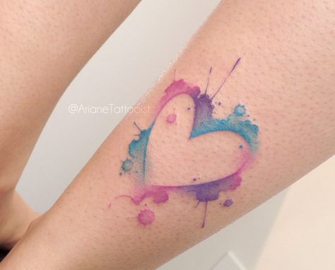 Watercolor Tattoos: Splatter Heart. A heart tattoo that uses watercolor style to create a blue, pink, and purple splattering effect. Click through for 20 watercolor tattoo ideas. #watercolortattoos #tattooideas #tattoos IG: @arianetattooist Purple Heart Tattoos, A Heart Tattoo, Watercolor Heart Tattoos, Traditional Heart Tattoos, Watercolor Tattoo Ideas, Purple Tattoos, Pink Tattoo, Small Watercolor, Tattoos With Kids Names