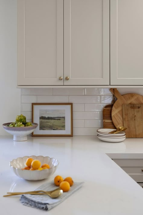 neutral kitchen details Greige Kitchen Black Counter, French Farmhouse Kitchen Backsplash, Tan Cabinet Kitchen, Bevel Subway Tile Backsplash, Calcutta Quartz Counter Tops Backsplash, Long White Subway Tile Kitchen, 2x12 Subway Tile Backsplash, Ivory Quartz Countertop, Horizontal Backsplash Kitchen