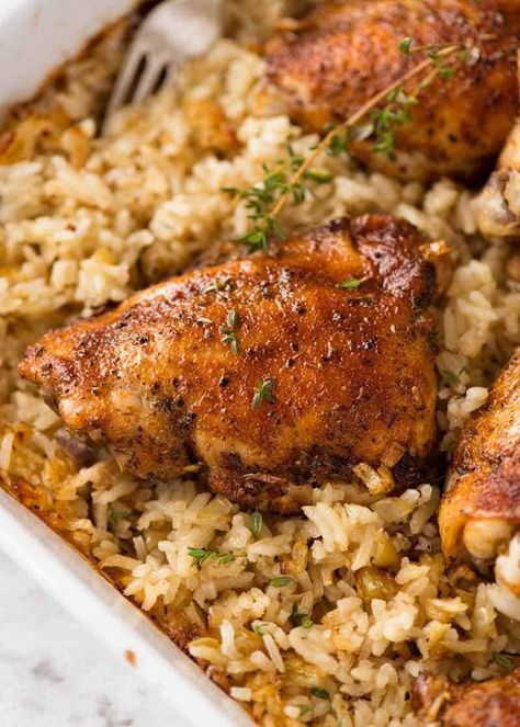 Close up of Baked Chicken and Rice in a white baking dish fresh out of the oven Baked Chicken And Rice, Arabisk Mad, Rice Dinner, Oven Baked Chicken, Chicken And Rice, Baked Chicken Recipes, Poultry Recipes, Casserole Dish, Oven Baked