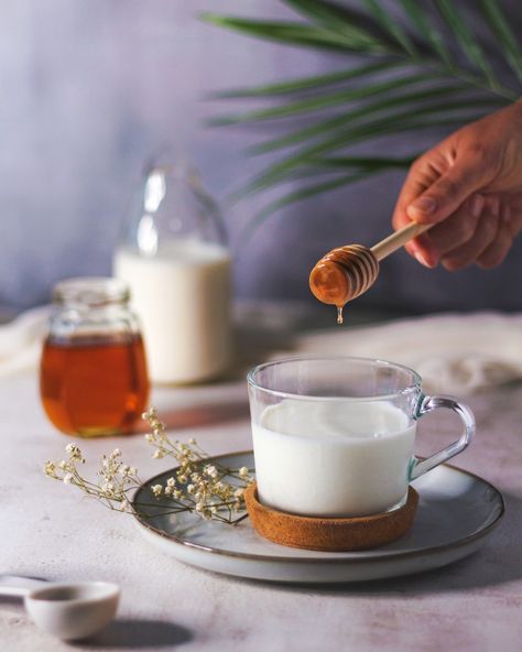 Pouring honey drops in a cup of milk Milk And Honey Aesthetic, Honey Pouring, Honey Shoot, Milk With Honey, Almond Milk Brands, Warm Milk And Honey, Bike Cakes, Inspired Photos, Honey Milk