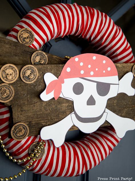 DIY PIRATE PARTY WREATH with free printable skull and crossbones pirate w an eye patch. Pirate party decorations ideas. Great to decorate the entrance to your pirate party with full video tutorial. Fun pirate great for kids parties. Can be made with items from the dollar store. Centerpiece of a Halloween pirate ship on the front porch made with cardboard. Check out all the pirate party posts. #pirate #party #decorations #wreath #diy - By Press Print Party! Diy Pirate Party, Jellyfish Costume Diy, Pirate Wreath, Ghost Lollipops, Pirate Halloween Party, Diy Pirate, Pirate Party Decorations, Mermaid Pirate Party, Light Up Hats