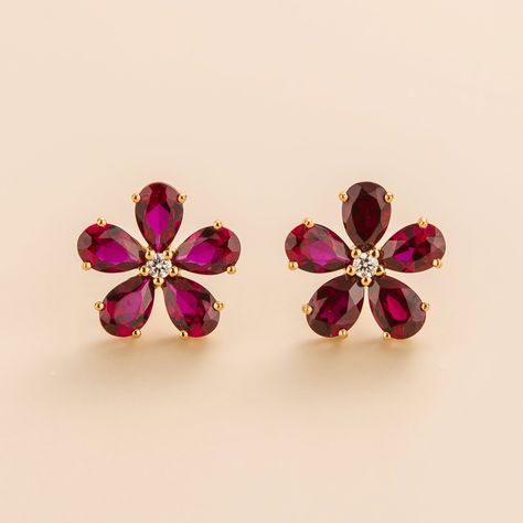 Florea earrings in 18K pink gold vermeil set with Ruby and DiamondRuby: 5.0 carats (10 of 6mm x 4mm pear cut stones)Diamond: 0.1 carats (2 of 2mm round cut stones)Options available to make the earrings in 9K, 14K and 18K gold. Please contact us at contactus@juvetti.com. Our precious jewellery is designed to preserve its original brilliance over time. There are a few precautions to make sure to keep your jewellery in the best condition.Your jewellery should be cleaned regularly using clean and dr Red Stone Earrings, Flower Earrings Gold, Ruby Earrings Studs, Round Flower, Bridal Gold Jewellery Designs, Ruby Earrings, Gold Earrings Designs, Bridal Gold Jewellery, Christmas 2023