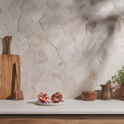 Effortless style meets organic beauty in the Countryside Organica collection. An oversized scale and irregular geometric shapes give this cobblestone-look marble a modern twist. The interlocking pattern is glued to a mesh backing for easy installation. Available in neutral grey or white, this tile is enhanced by sleek lines for a dynamic effect. At nearly 12-by-20 inches, the versatile collection makes a statement indoors or out. | Ivy Hill Tile Countryside Organica Marble Mosaic White 19.68 x 1 Dining Japandi, Tiles Herringbone, Interior Japandi, Chevron Tiles, Kitchen Japandi, Japandi Aesthetic, Japandi Dining, Tiles Terracotta, Herringbone Tiles