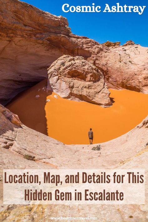 A man is standing in front of a huge pothole which is filled with orange sand. In the middle of the pothole is a rock looking out. The sun is shining into the Cosmic Ashtray with a clear blue sky. Cosmic Ashtray Utah, Grand Staircase Escalante, Escalante National Monument, Cross Country Trip, Utah Adventures, Utah Hikes, Hiking Guide, Utah Travel, Utah National Parks