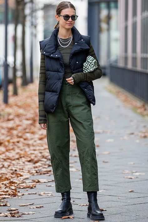 6 Ways to Wear a Puffer Vest in 2022, and 1 That’s Majorly Dated #purewow #outerwear #fashion #style #trends #shopping #shoppable #winter #street style #outfit ideas Street Style Winter 2022 Trends, Winter Street Style 2022 Women, Black Down Vest Outfit Womens, 2022 Winter Street Style, Long Down Vest Outfit, 2022 Fall Street Style, Fall 2022 Street Style Trends, Europe Winter Street Style, Camo Puffer Vest Outfits