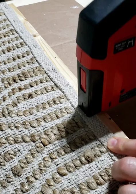 My daughter wanted a new headboard for her room. She had some ideas she saw on the internet so we took a rug she found at Hobby Lobby and, with some scrap wood, designed and built her a simple headboard. We purchased the rug from Hobby Lobby and laid it out for measurement. Now, the rug is able to be stretched but you don't want to stretch it too much since that can put strain on your staples that will hold the rug to the frame. Once I got the length and width, I added one inch to… Rug For Headboard, Rug Headboard Diy, Rug Headboard Ideas, Diy Rug Headboard, Add Headboard To Platform Bed, Jute Rug Headboard Diy, Diy Headboard Herringbone, Attach Headboard To Bed Frame, Adding Fabric To Wood Headboard